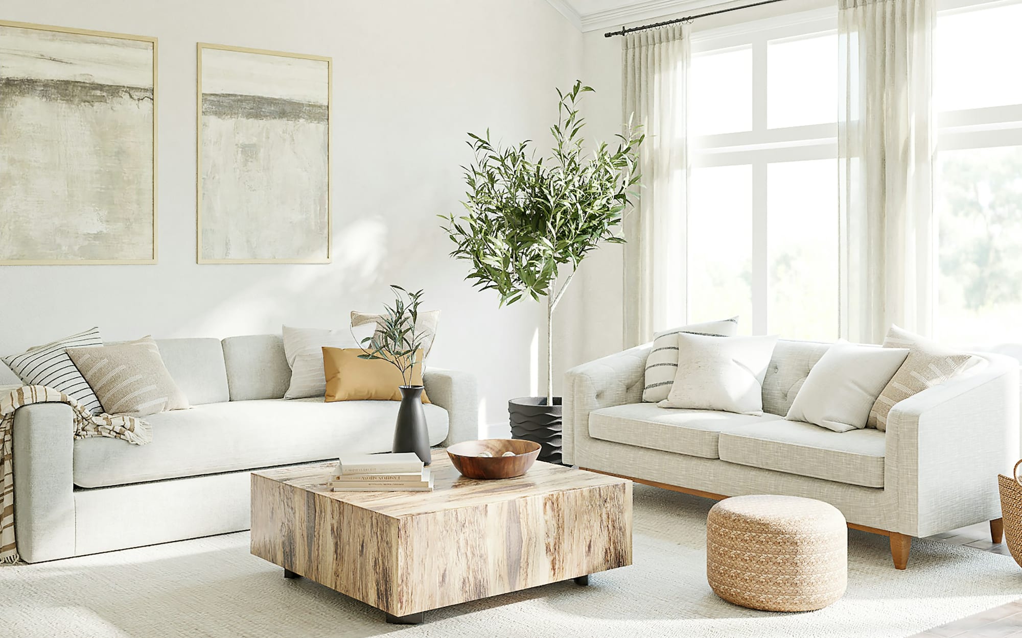 A bright, spotlessly clean living room with white sofas and large sunlit windows